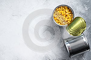 Canned corn in a tin can. canned food. White background. Top view. Copy space