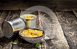 Canned corn in a tin can with fork.