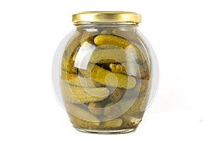 Canned cucumbers on a white background in a glass jar
