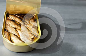 Canned fish on a gray background. Tinned fish concept. Horizontal orientation.