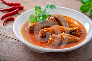 Canned fish in tomato sauce on plate