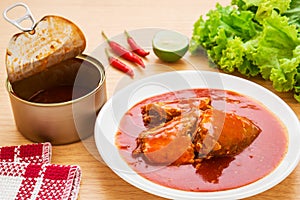 Canned fish in tomato sauce on plate