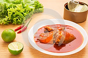 Canned fish in tomato sauce on plate