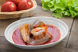 Canned fish in tomato sauce on plate