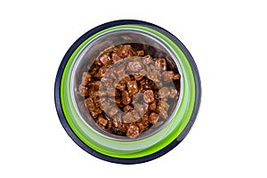 Canned food for cats or dogs in metal green bowl isolated on white background