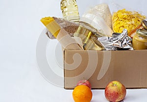 Canned food, pasta and cereals cardboard box. Food donations or food delivery concept.