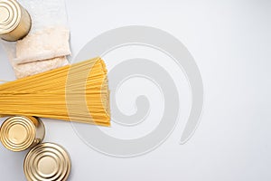 Canned food, pasta, groats and pasta on a blue background. Donates for low-income families during the coronavirus