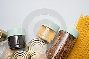 Canned food, pasta, groats and pasta on a blue background. Donates for low-income families during the coronavirus