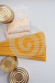 Canned food, pasta, groats and pasta on a blue background. Donates for low-income families during the coronavirus