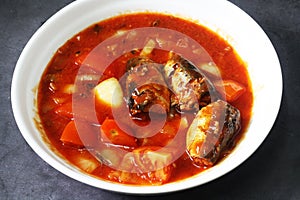 Canned food sardine with tomato on white plate. Home cooked food