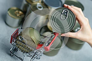 Canned food in shopping cart toy with Hand , group of Aluminium canned food