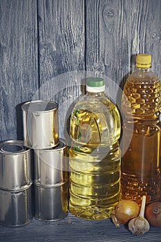 Canned food and vegetable oil on a wooden shelf, food crisis