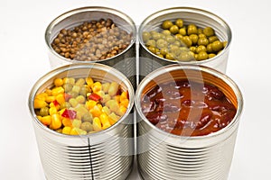 Canned food on white background. Green pea, beans, corn, lentils