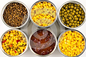 Canned food on white background. Green pea, beans, corn, lentils