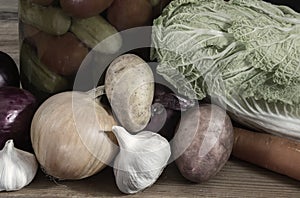 Canned and fresh vegetables on a wooden shelf