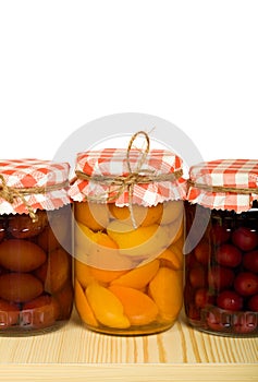 Canned fruits on the shelf - isolated