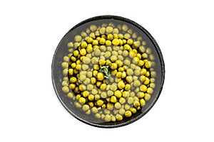 Canned green peas in a frying pan. Canned food. Isolated, white background.