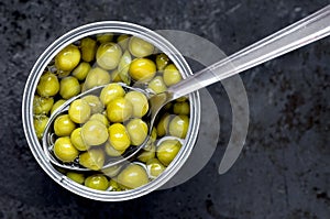 Canned green peas tin can with a spoon