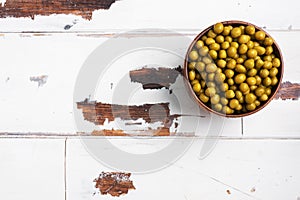 Canned green peas in a wooden bowl. Homemade fermented food. copy space