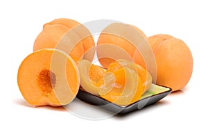 Canned peach halves in plate