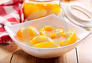 Canned peaches in a bowl