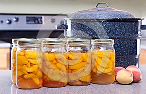 Canned peaches with large pot or canner photo