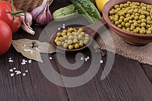 Canned peas and vegetables on an old wooden table.