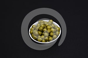 Canned peas in a white salad bowl. Delicious fresh peas