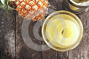 Canned pineapple on wood background