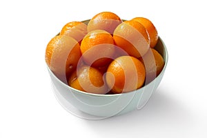 Canned plums in a bowl on a white background.