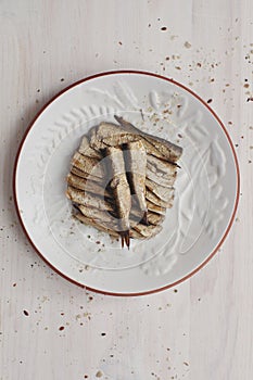 Canned sprats on dish