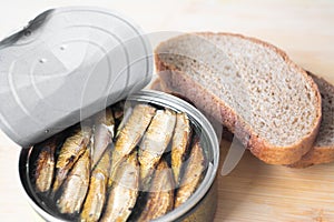 Canned sprats on rye bread served with herb baked potatoes