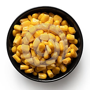 Canned sweet corn in a black ceramic bowl isolated on white. Top view