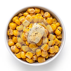 Canned sweet corn with a knob of butter and ground black pepper in a white ceramic bowl isolated on white. Top view