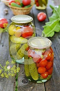 Canned tomatoes, cucumbers and garlic in glass jar