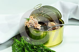 Canned tuna from albacore white meat without soy, packed in water. an open tuna can on the table.