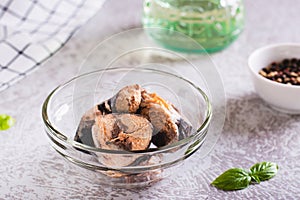 Canned tuna chunks in a bowl on the table