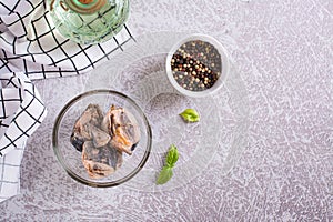 Canned tuna chunks in a bowl on the table top view