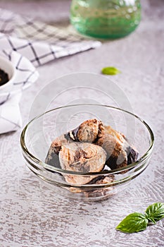 Canned tuna chunks in a bowl on the table vertical view