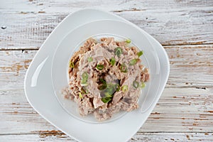Canned tuna chunks decorated with sliced green onion