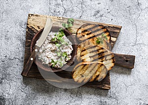 Canned tuna, cream cheese, herb pate and grilled bread on a cutting Board, top view. Delicious tapas, appetizer, snack