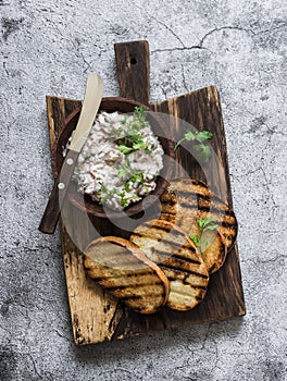 Canned tuna, cream cheese, herb spread pate and grilled bread on a cutting board, top view. Delicious tapas, appetizer, snack