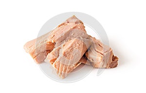 Canned tuna fillet pieces isolated on white background. Preserved seafood as ingredient for low calories diets and healthy eating