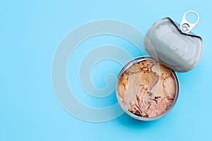 Canned tuna fish on blue background