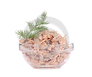 Canned tuna in glass bowl and dill.