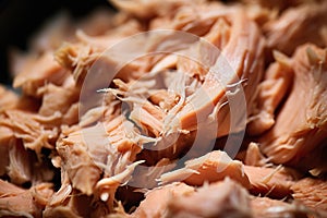 Canned tuna shredded closeup. Texture of flaked tuna