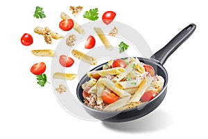 Canned Tuna tomato garlic parsley pasta in a pan on a white isolated background