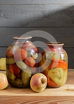 Canned vegetables in glass jars on a shelf in the basement