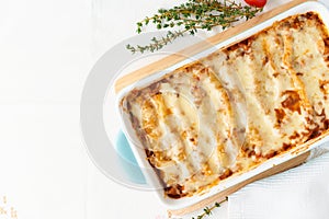 Cannelloni pasta with filling of ground beef, tomatoes, baked with bechamel tomato sauce and mozzarella. Classical Italian cuisine