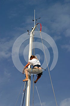 Sailor climbing mast